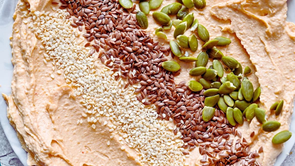 close up visual of hummus with sesame seeds